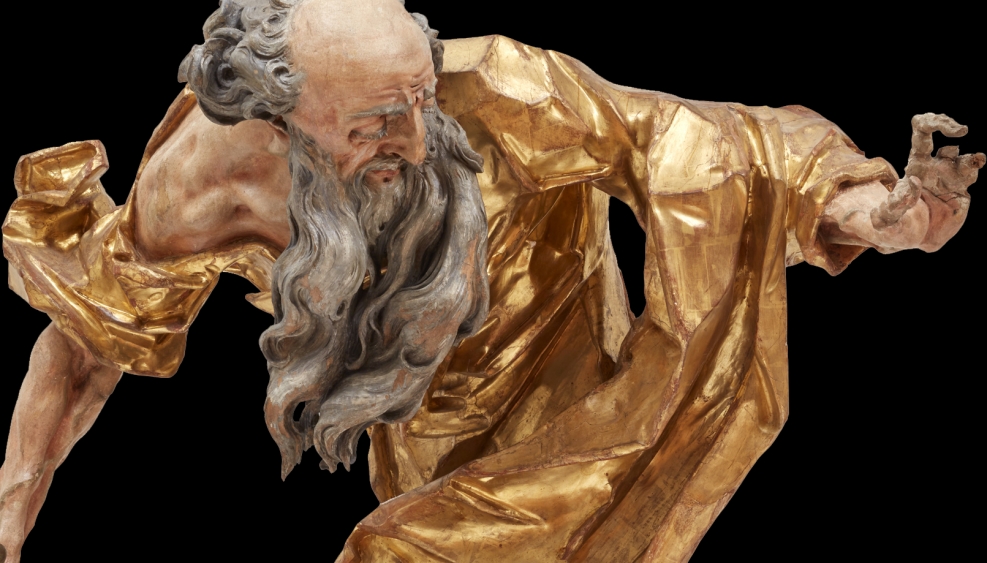 drewniana złocona rzeźba przedstawiająca starego brodatego mężczyznę w ekspresyjnej postawie
