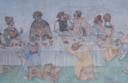 fragment naściennego malowidła, przedstawia grupę ludzi w dawnych strojach, siedzą za stołem, jedzą, rozmawiają