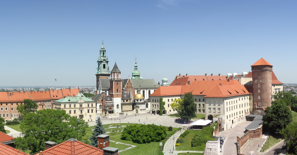 Wzgórze wawelskie - dziedziniec zewnętrzny z trawnikami i drzewami, ścieżki, budynki zamku i katedry, w tle niebo